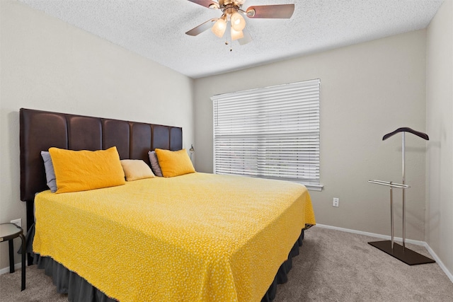 carpeted bedroom featuring a textured ceiling, baseboards, and a ceiling fan