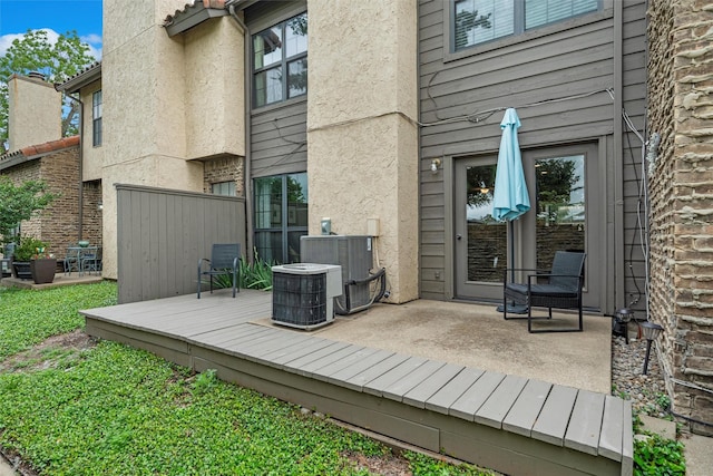 wooden deck with fence and cooling unit