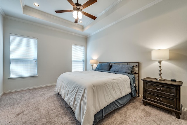 bedroom featuring carpet floors, ornamental molding, a raised ceiling, and baseboards