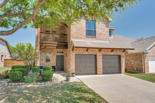 traditional-style home featuring brick siding, a balcony, concrete driveway, an attached garage, and a shingled roof