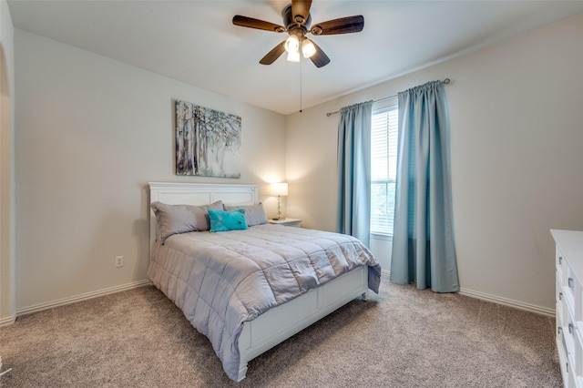 bedroom with a ceiling fan, baseboards, and light carpet