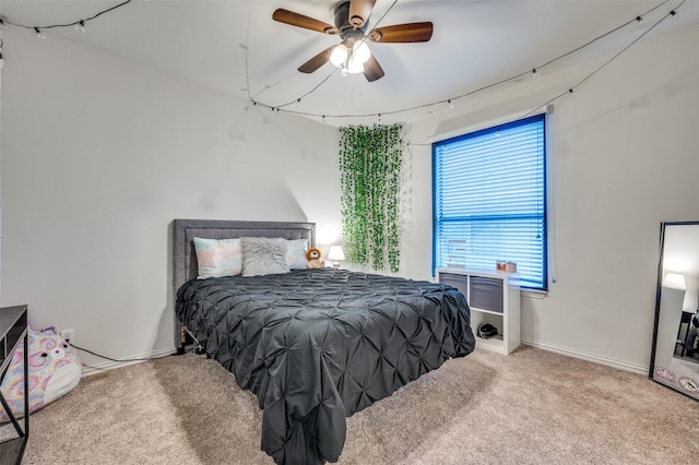 carpeted bedroom featuring baseboards and ceiling fan