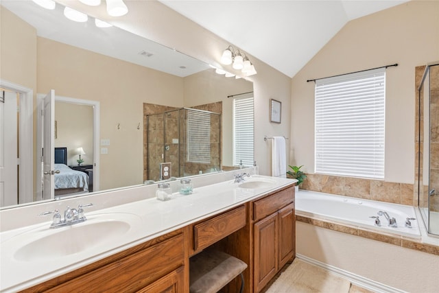 ensuite bathroom with ensuite bathroom, a sink, double vanity, and a shower stall