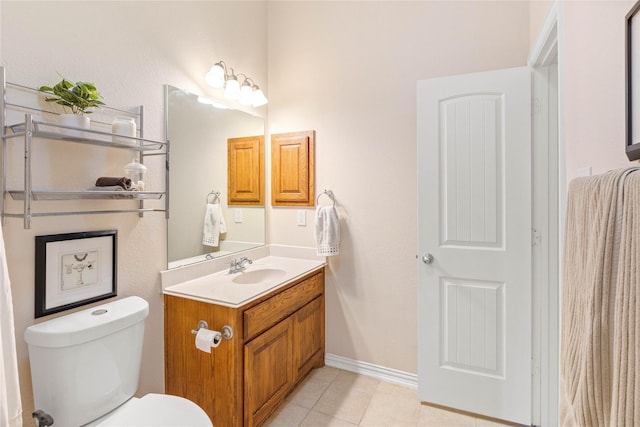 bathroom with toilet, tile patterned floors, baseboards, and vanity