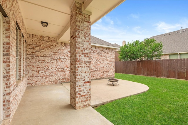 exterior space with a patio area, an outdoor fire pit, and fence
