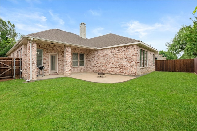 rear view of property featuring a fenced backyard, a patio area, and brick siding