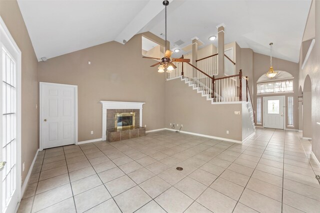 2806 Glenwick Ct, Richardson, TX 75082 - unfurnished living room with high vaulted ceiling, ceiling fan, stairs, a fireplace, and light tile patterned floors