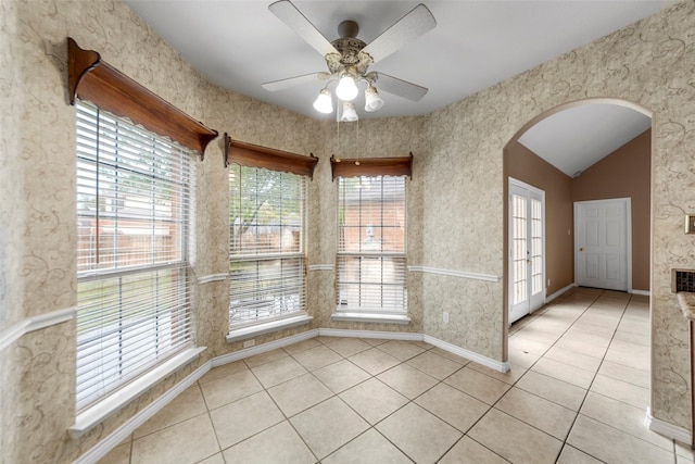 2806 Glenwick Ct, Richardson, TX 75082 - spare room featuring arched walkways, light tile patterned floors, ceiling fan, baseboards, and lofted ceiling