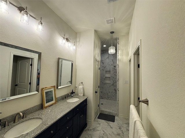 full bath featuring visible vents, a shower stall, a sink, and marble finish floor