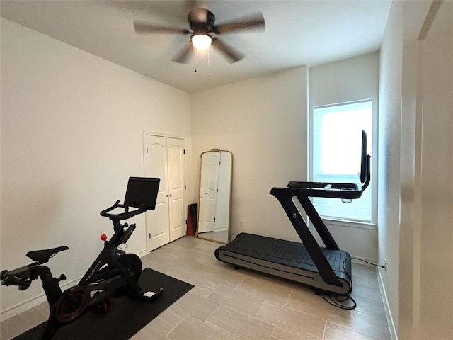 workout area featuring ceiling fan, plenty of natural light, and baseboards