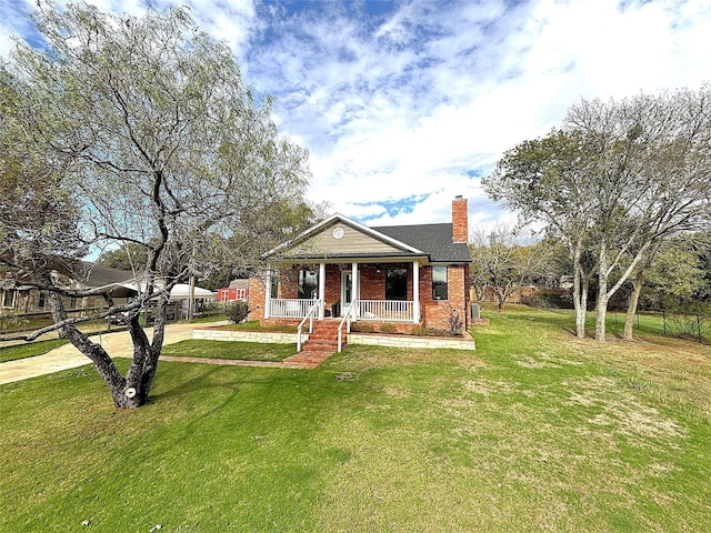 bungalow featuring a porch, brick siding, a front lawn, and a chimney