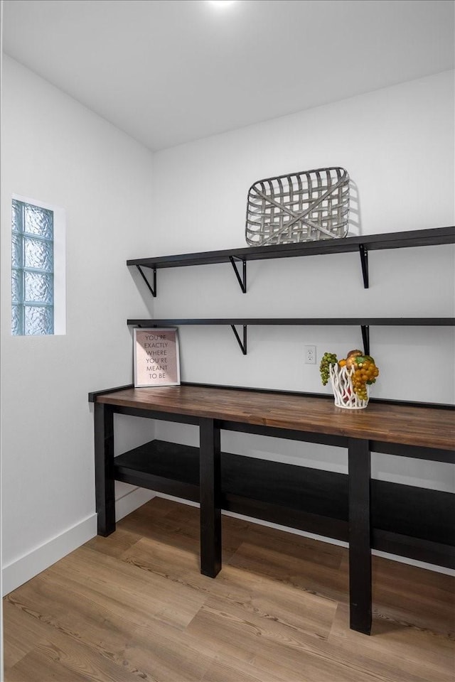 room details with baseboards and wood finished floors
