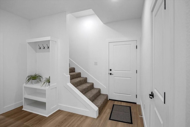 interior space with baseboards and wood finished floors