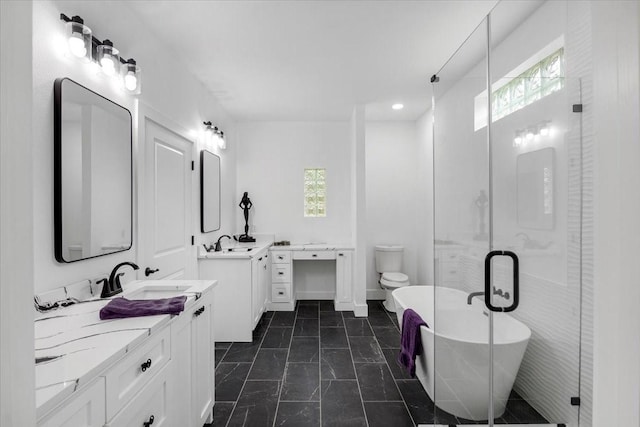 full bath with plenty of natural light, a sink, and two vanities