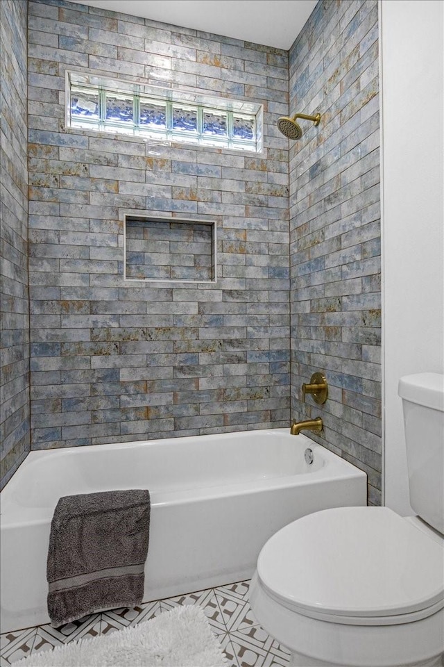 bathroom featuring shower / tub combination, tile patterned floors, and toilet