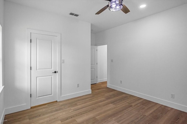 unfurnished bedroom with visible vents, a ceiling fan, light wood-style flooring, and baseboards
