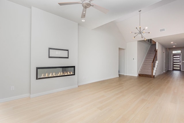 4313 Brookridge Ave, Mckinney, TX 75071 - unfurnished living room with stairs, high vaulted ceiling, visible vents, and wood finished floors