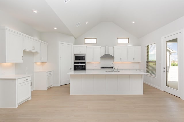 4313 Brookridge Ave, Mckinney, TX 75071 - kitchen featuring oven, an island with sink, wall chimney range hood, stainless steel microwave, and a sink