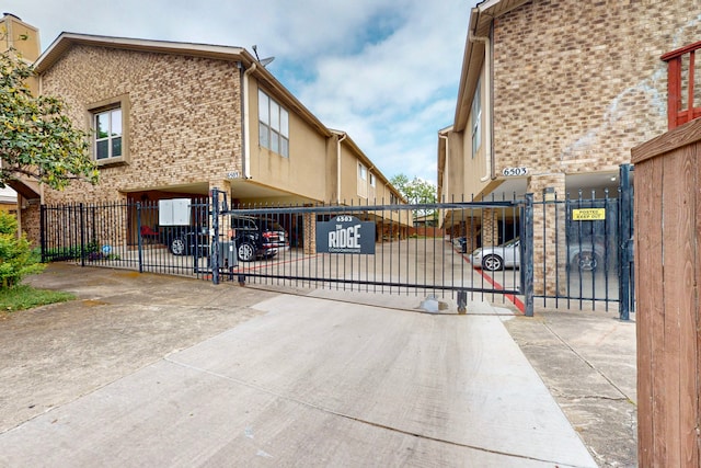 view of gate with a fenced front yard
