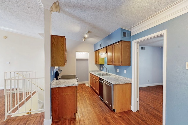 kitchen with visible vents, a sink, and wood finished floors