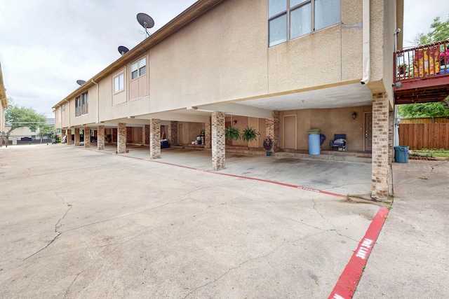 view of vehicle parking featuring fence