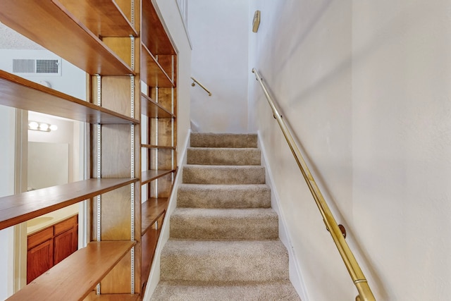 stairway featuring carpet and visible vents