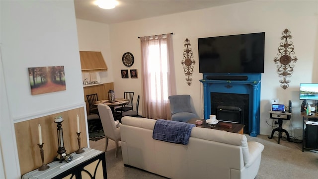 living room with a fireplace and light carpet