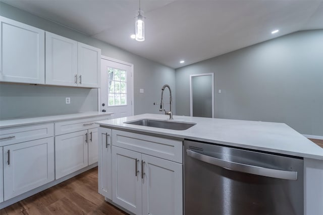 kitchen with stainless steel dishwasher, dark wood finished floors, a sink, light countertops, and white cabinetry
