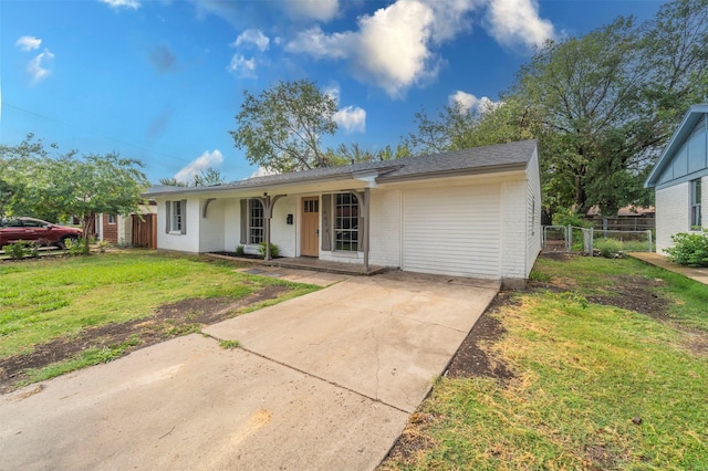 ranch-style house with a front lawn, fence, covered porch, brick siding, and driveway