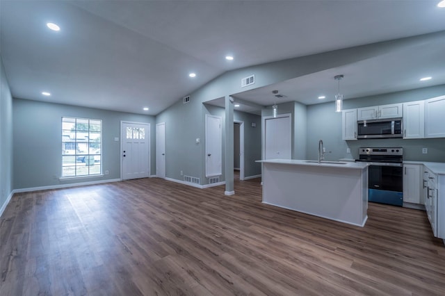 kitchen featuring dark wood-style flooring, visible vents, a sink, light countertops, and stainless steel appliances