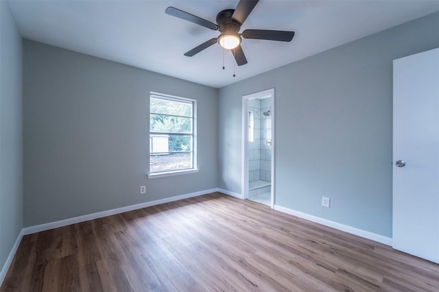 unfurnished room with baseboards, a ceiling fan, and wood finished floors