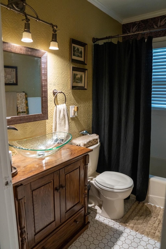 bathroom with crown molding, vanity, and toilet
