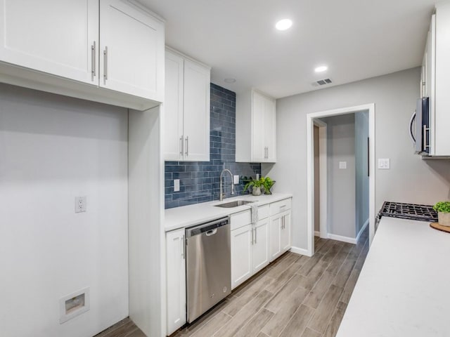 kitchen featuring visible vents, light countertops, white cabinetry, a sink, and appliances with stainless steel finishes