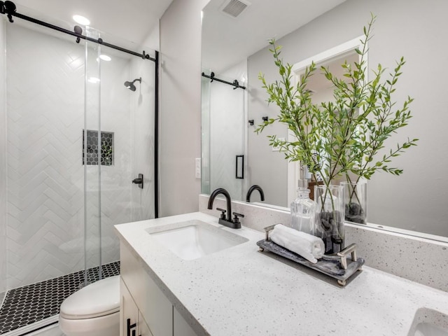 full bathroom featuring toilet, visible vents, a shower stall, and vanity