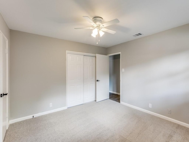 unfurnished bedroom with visible vents, carpet, and baseboards