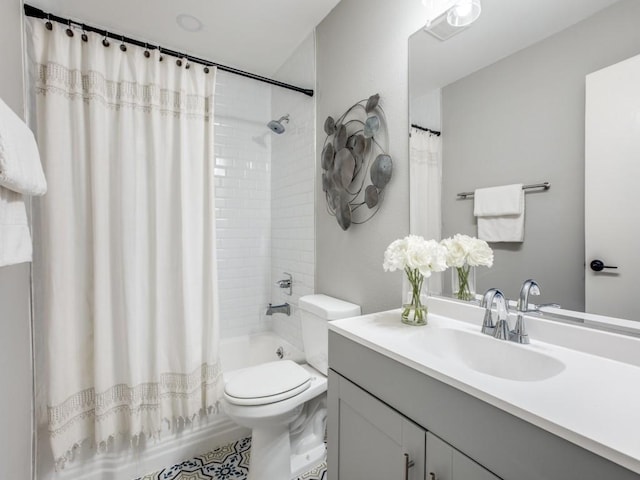 bathroom featuring toilet, shower / bath combination with curtain, and vanity