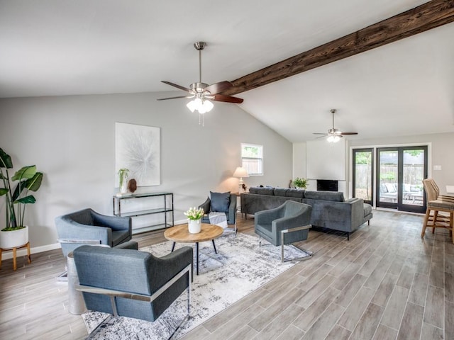 living room with vaulted ceiling with beams, a ceiling fan, baseboards, and light wood-type flooring