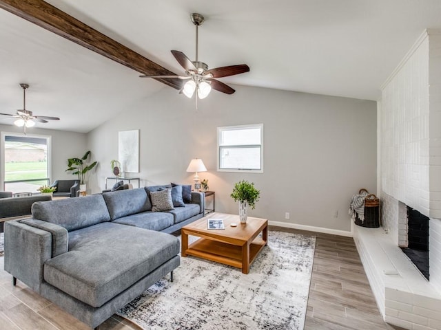 living area featuring ceiling fan, a healthy amount of sunlight, and light wood-style flooring