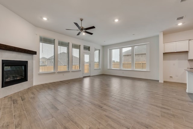 unfurnished living room featuring ceiling fan, light wood finished floors, recessed lighting, and visible vents