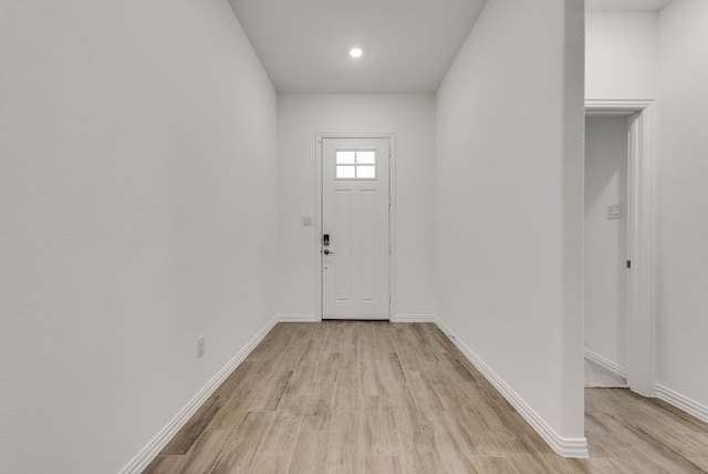 doorway to outside with light wood-type flooring, recessed lighting, and baseboards