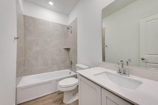 full bath featuring vanity, shower / bathtub combination, toilet, recessed lighting, and wood finished floors
