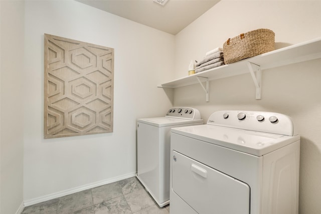 washroom with washer and dryer, laundry area, and baseboards