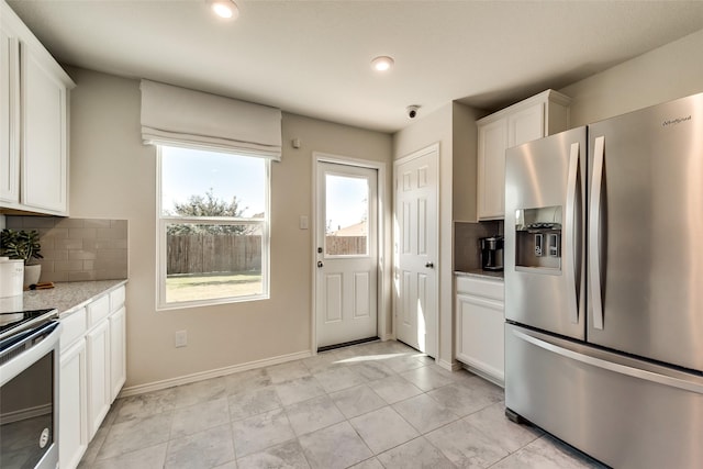 2415 Carlow Ln, Lowry Crossing, TX 75407 - kitchen with electric range, stainless steel microwave, white cabinetry, and tasteful backsplash