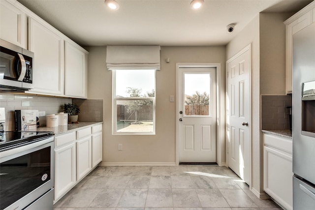 2415 Carlow Ln, Lowry Crossing, TX 75407 - kitchen featuring white cabinets, backsplash, stainless steel appliances, and light stone countertops