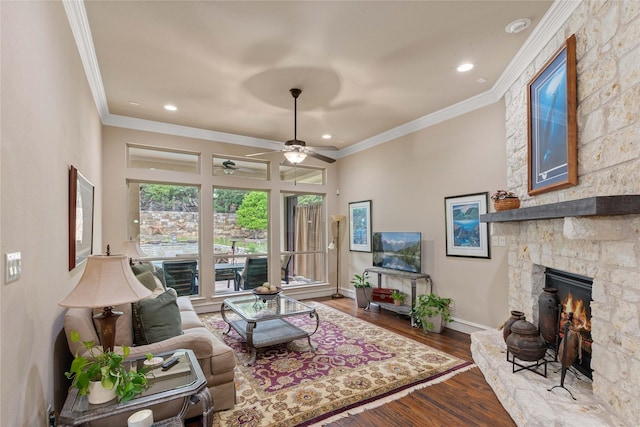 5916 River Highlands Dr, Mckinney, TX 75070 - living area featuring a stone fireplace, ornamental molding, ceiling fan, wood finished floors, and baseboards