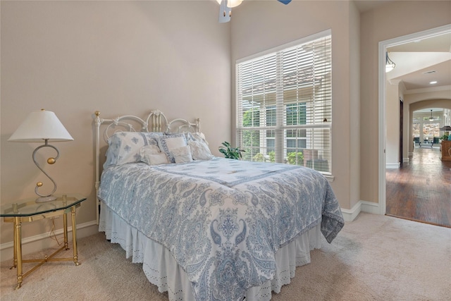 5916 River Highlands Dr, Mckinney, TX 75070 - bedroom with light colored carpet, baseboards, and arched walkways