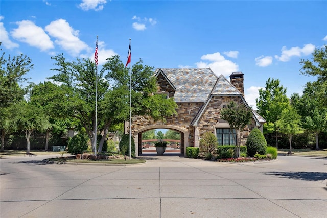 5916 River Highlands Dr, Mckinney, TX 75070 - view of front of property with stone siding, a high end roof, and a chimney