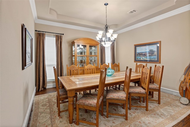 5916 River Highlands Dr, Mckinney, TX 75070 - dining space featuring a chandelier, a raised ceiling, light wood-style floors, baseboards, and crown molding
