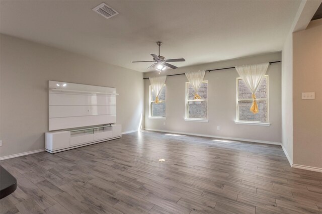 1800 Emilia Dr, Celina, TX 75009 - unfurnished living room featuring ceiling fan, wood finished floors, and baseboards