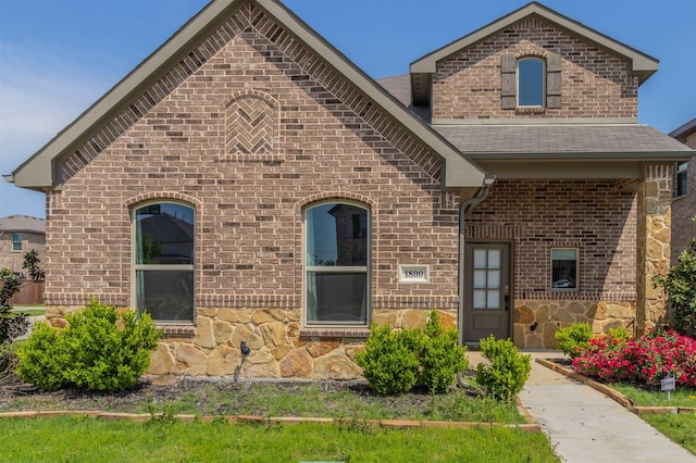 1800 Emilia Dr, Celina, TX 75009 - french country style house featuring brick siding, stone siding, and roof with shingles